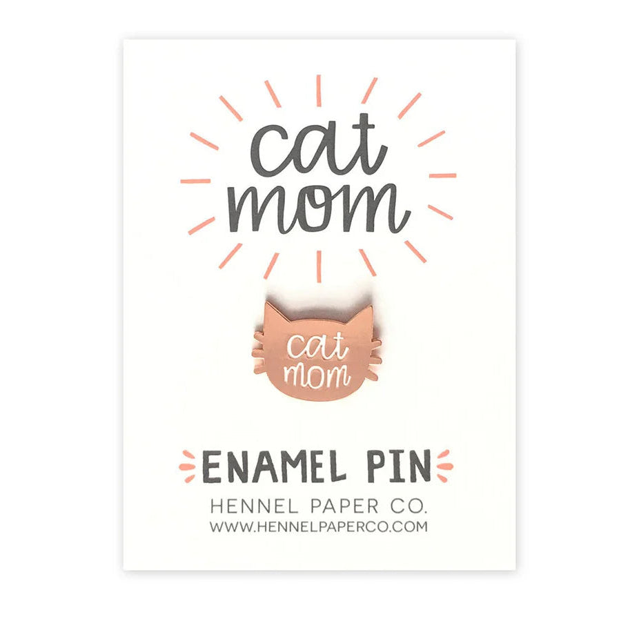Enamel pin packaging with 'cat mom' text and brand name Hennel Paper Co on a white background
