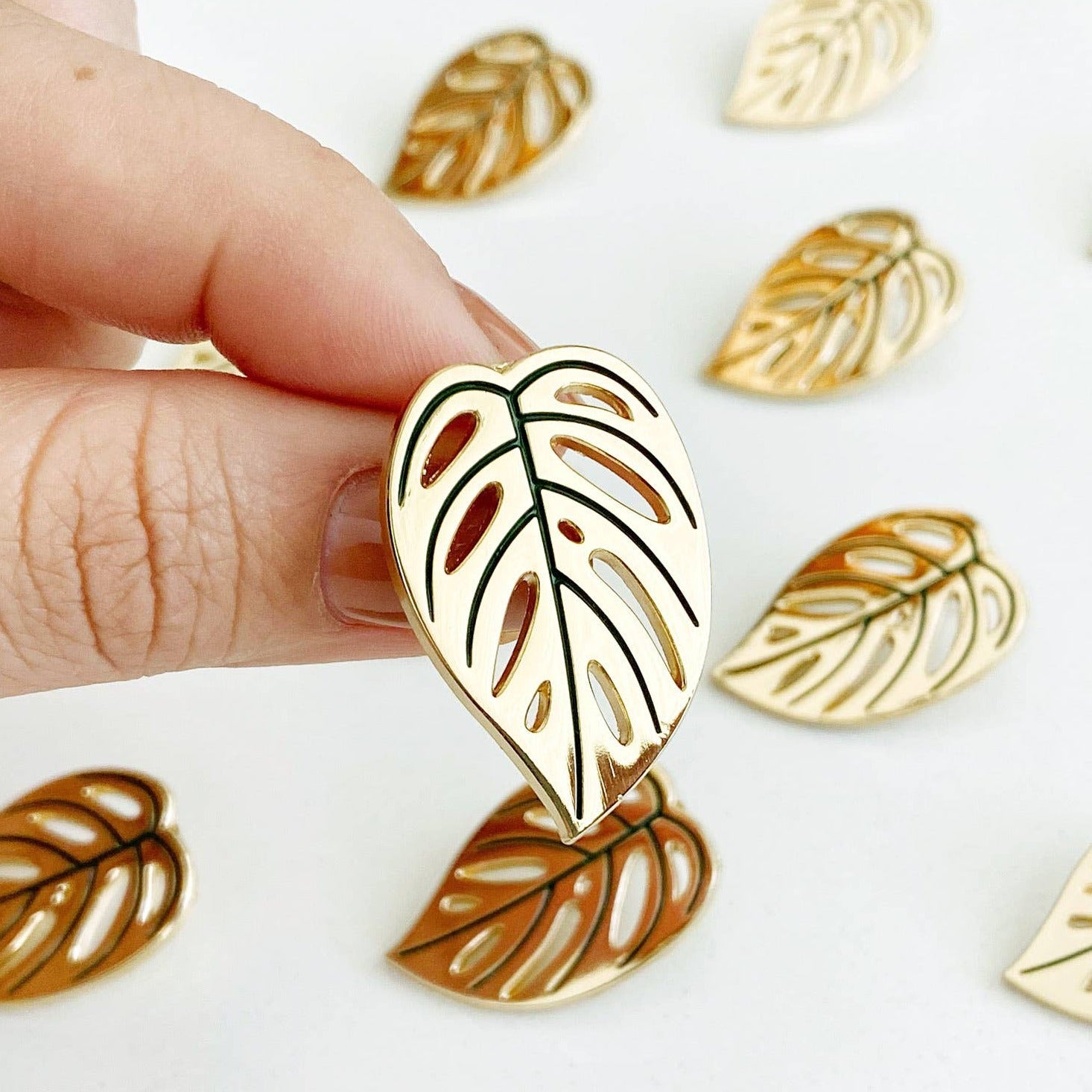 Beautiful monstera adansonii plant "Swiss cheese" leaf 18 karat gold plated lapel pin with a single-prong backing.